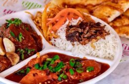 Plate of butter chicken, rice and vindaloo from Tiffin